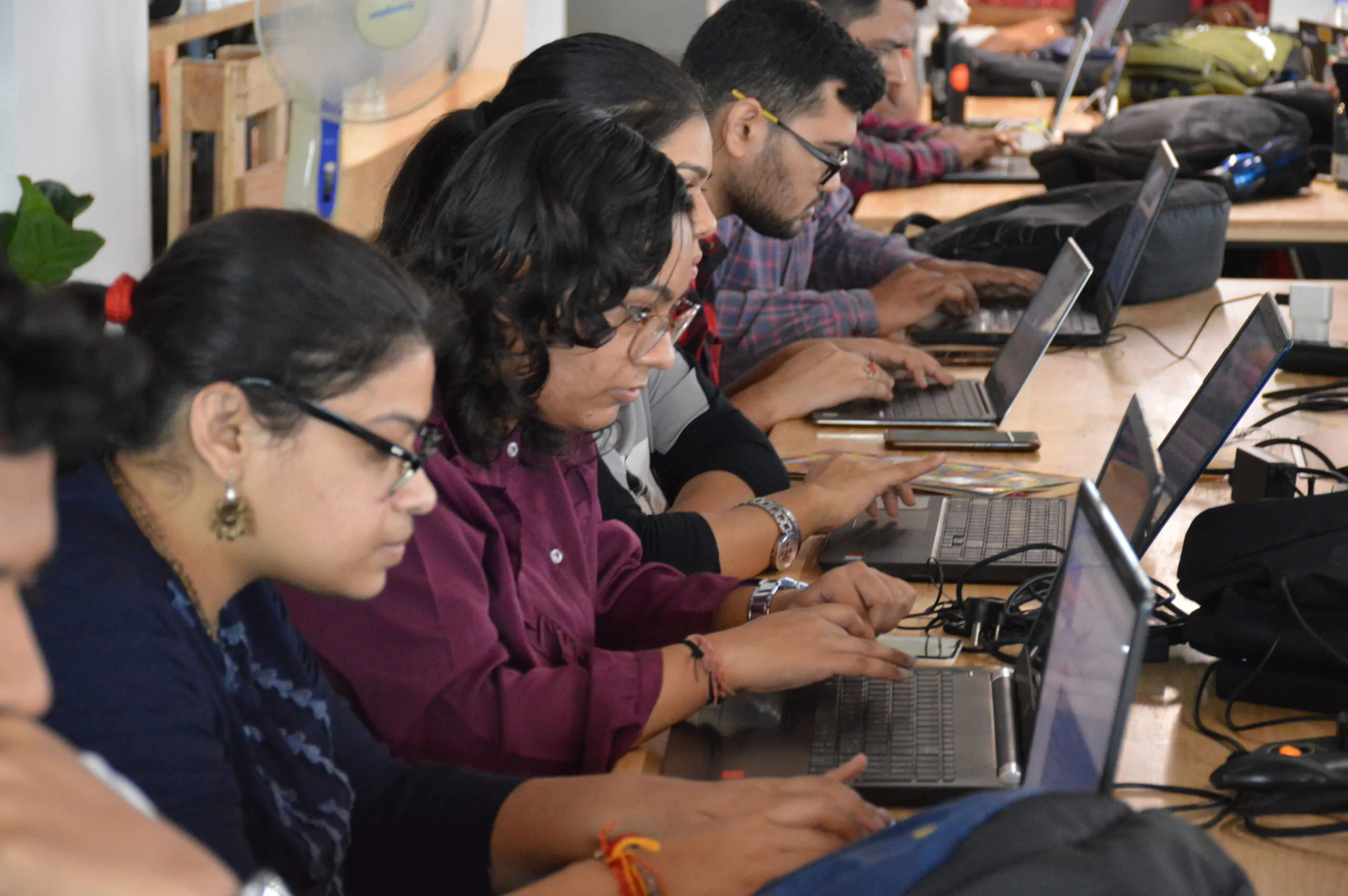 Four students working in a laptop